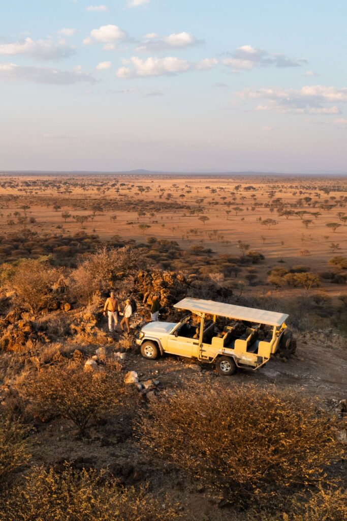 Couple enjoying a private African safari at sunset