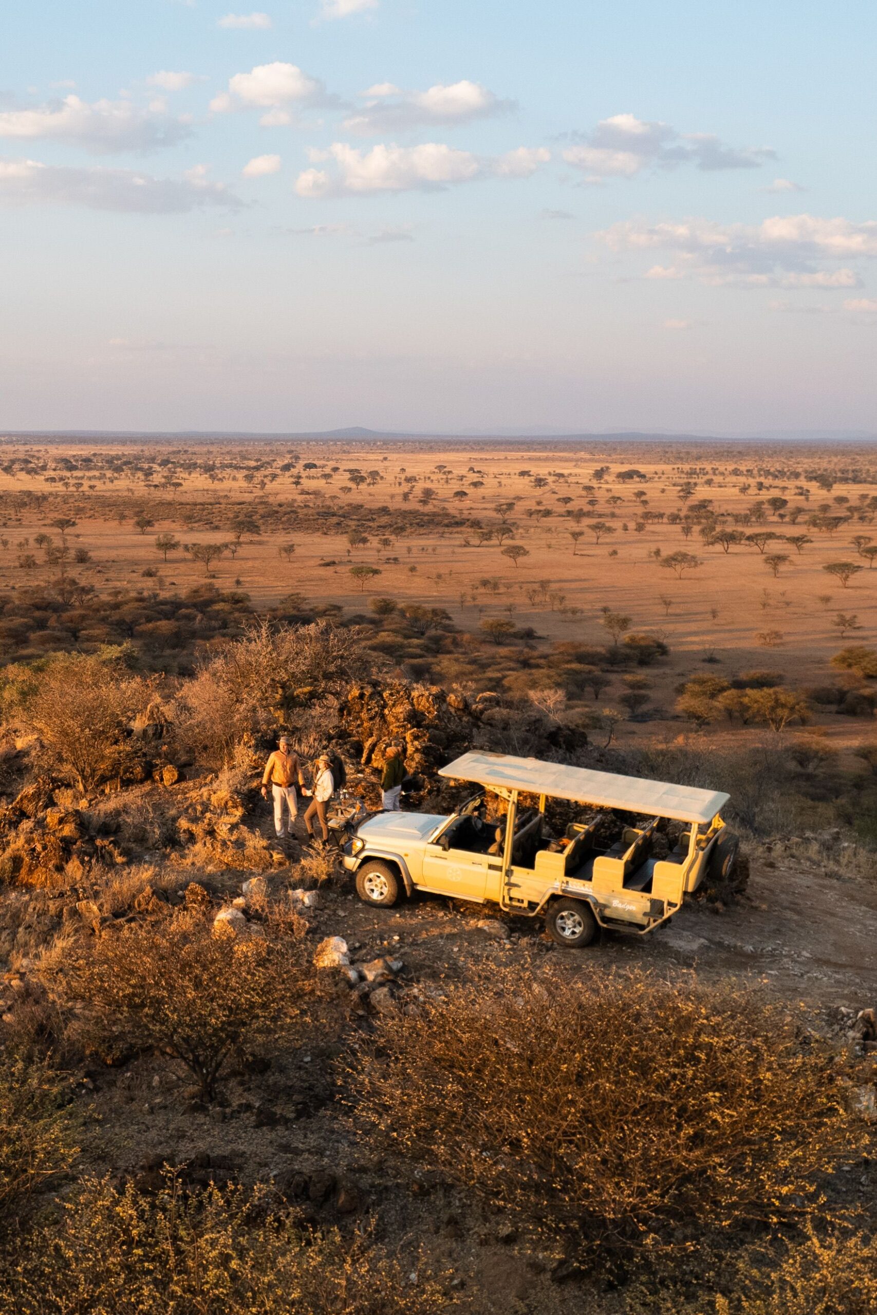 Couple enjoying a private African safari at sunset