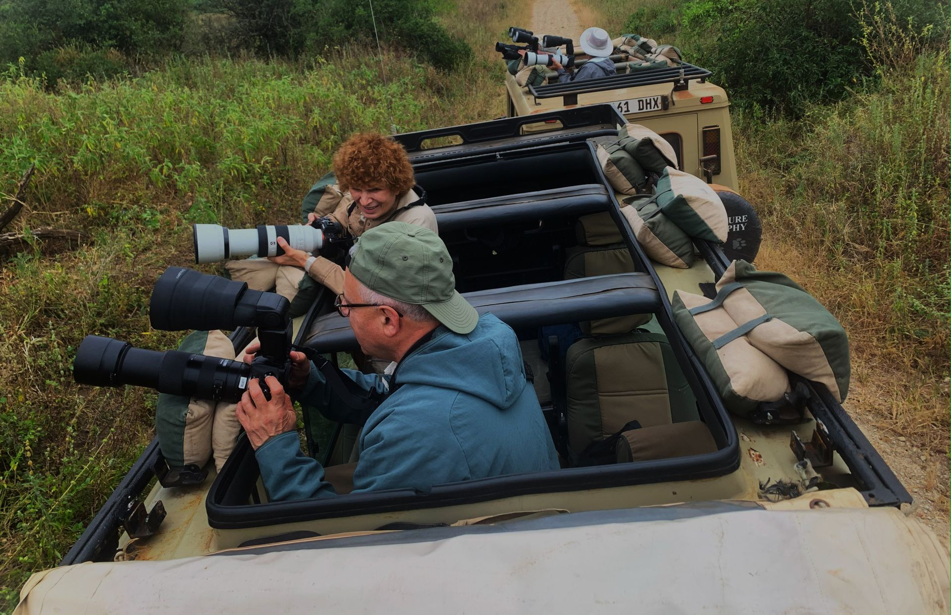 Wildlife photographers using telephoto lenses on safari